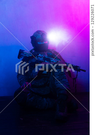 Tactical Soldier in Action Helmet On Off Dramatic Lights Smoke 129226071