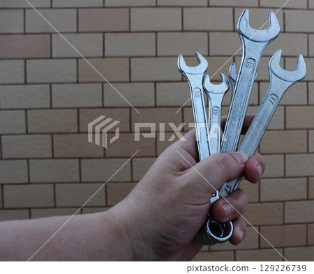 Bunch Of Steel Hex Wrenches In A Hand Of Mechanician Stock Photo Bunch Of Steel Hex Wrenches In A Hand Of Mechanician Stock Photo 129226739