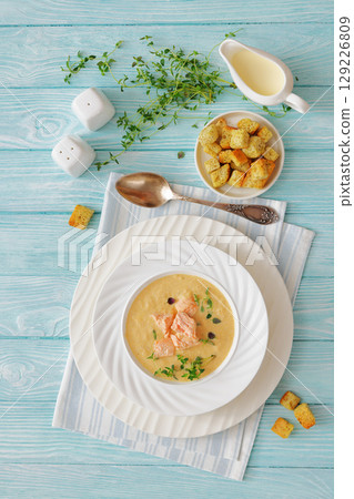 creamy salmon soup with herb in a bowl 129226809