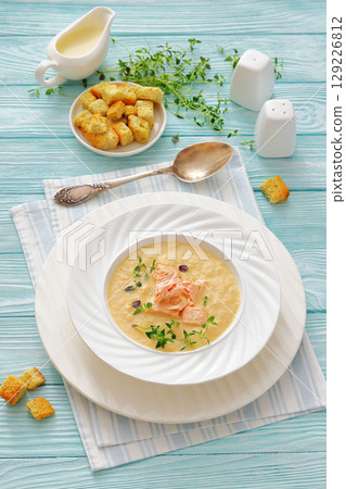 creamy salmon soup with herb in a bowl 129226812