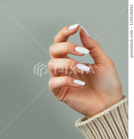Hand with white squoval nails manicure, ai generated, green background 129226842