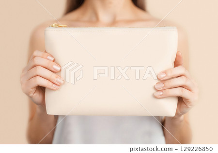 Blank leather cosmetic bag in hand mockup, ai generated 129226850