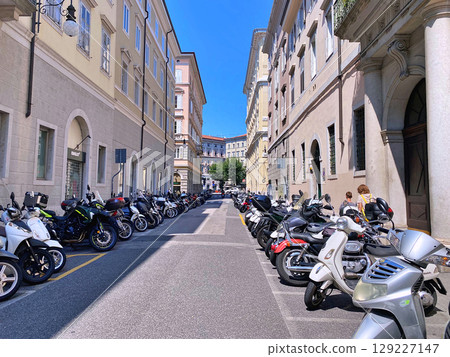 Parking of motorcycles on both sides of the street in the city centre. Trieste, region Friuli-Venezia Giulia, Italy Parking of motorcycles on both sides of the street in the city centre. Trieste, region Friuli-Venezia Giulia, Italy 129227147