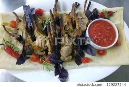 veal ribs with cherry tomatoes, hot peppers and tomato sauce veal ribs with cherry tomatoes, hot peppers and tomato sauce 129227244