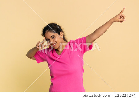 Indian woman joyfully dancing, imagining herself performing on stage, rhythmically enjoying music Indian woman joyfully dancing, imagining herself performing on stage, rhythmically enjoying music 129227274