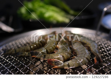 grilled shrimp with local white wine in a tavern on Santorini island in Greece grilled shrimp with local white wine in a tavern on Santorini island in Greece 129227286