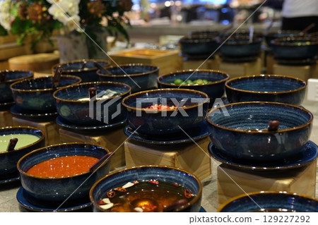 Full Table of Chinese Buffet Featuring Steamed Dim Sum, Salads, Snacks, Fried and Baked Dim Sum, Noodles, Rice, and Soup Vibrant Asian Feast Spread 129227292