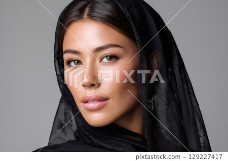 Beautiful muslim woman wearing hijab, posing in studio with black veil 129227417