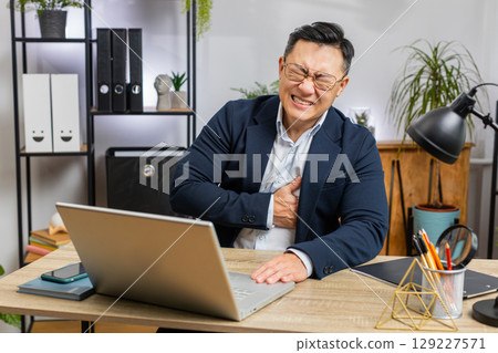Office business man suffers from tension holding chest with heart pain attack risk of stroke symptom Office business man suffers from tension holding chest with heart pain attack risk of stroke symptom 129227571