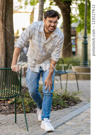 Indian young man suffer from painful severe knee joint ache, leg muscles illness cramps rheumatism Indian young man suffer from painful severe knee joint ache, leg muscles illness cramps rheumatism 129227612