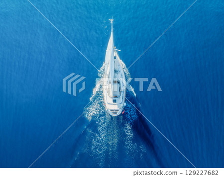 Sea and sail yacht as a background. Sea and waves from top view. 129227682