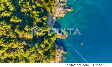 Vacation and relax at the summertime. Beach and blue water. Top view from drone at beach Vacation and relax at the summertime. Beach and blue water. Top view from drone at beach 129227686
