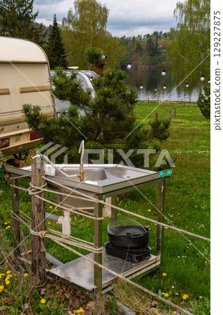Outdoor stainless steel sink with faucet and kitchen utensils at lakeside camping site Outdoor stainless steel sink with faucet and kitchen utensils at lakeside camping site 129227875