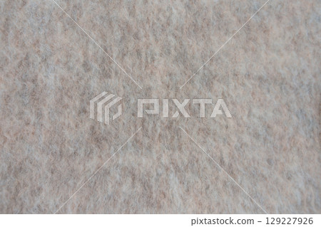 Close up of soft wool blend fabric with fuzzy beige texture and natural fibers for textile design. Close up of soft wool blend fabric with fuzzy beige texture and natural fibers for textile design. 129227926