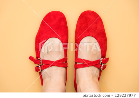 Red suede Mary Jane ballet flats shoes on feet, stylish womens spring footwear Red suede Mary Jane ballet flats shoes on feet, stylish womens spring footwear 129227977