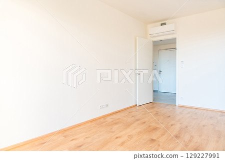 Modern empty apartment interior with wooden flooring and white walls. 129227991