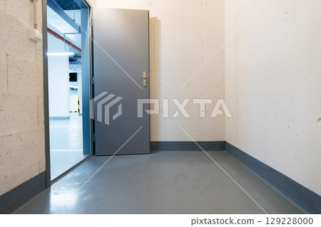 Secure underground storage room with metal door in modern parking facility Secure underground storage room with metal door in modern parking facility 129228000