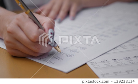 A gathering of friends engaged in a business meeting during summer, discussing plans while surrounded by nature and enjoying the warm sunlight. 129228134