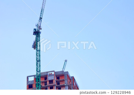 Construction industry.New building.Large high rise crane 129228946