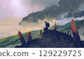 Traveler Resting on a Mountain Peak 129229725