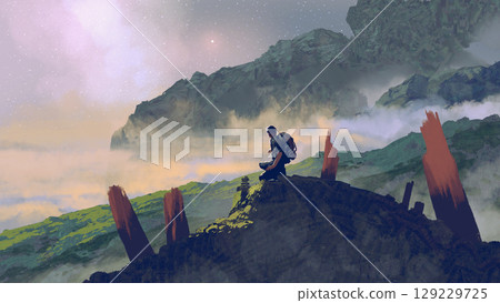Traveler Resting on a Mountain Peak 129229725