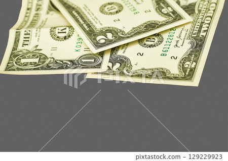 Money.Banknotes one, two dollars on gray Money.Banknotes one, two dollars on gray 129229923