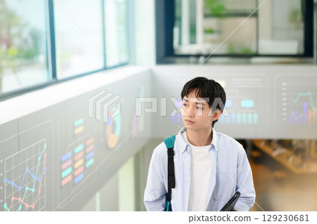 Male student walking down the hallway 129230681