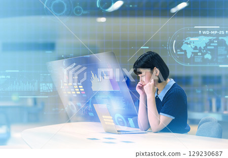 Future world: A female college student thinking while looking at a laptop 129230687