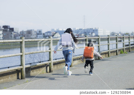 Elementary school students on their way to school Elementary school students on their way to school 129230894