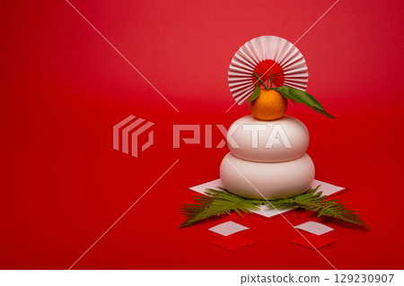 A photo of the Kagami mochi placed on the right, red background, no sanpo (pedestal) A photo of the Kagami mochi placed on the right, red background, no sanpo (pedestal) 129230907