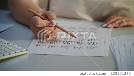 Close Up of Female Teacher Checking Math Homework of Students, Grading Mathematical Tests 129231273