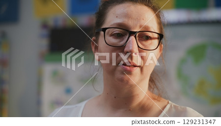 Female Teacher Talking and Conducting Lecture to Students, Teaching School Children 129231347