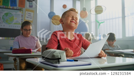 Teacher Giving Papers with School Test Results. Smart Boy Rejoicing and Celebrating Excellent Grade 129231584