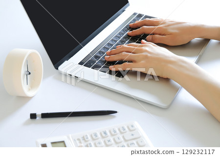 Hands working with a computer Hands working with a computer 129232117