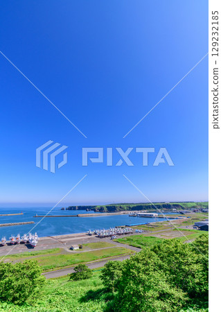 A view of Ochiishi town, the sea, and the mountains in Nemuro, Hokkaido 129232185