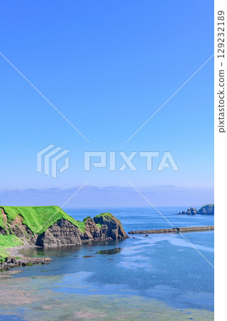 A view of Ochiishi town, the sea, and the mountains in Nemuro, Hokkaido A view of Ochiishi town, the sea, and the mountains in Nemuro, Hokkaido 129232189