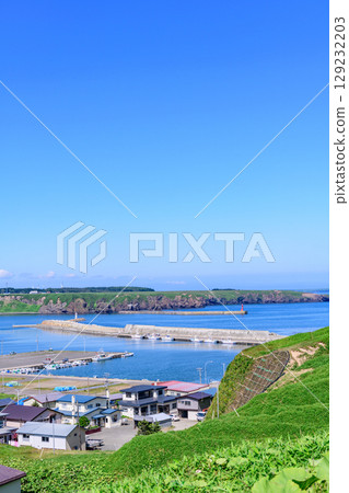 A view of Ochiishi town, the sea, and the mountains in Nemuro, Hokkaido 129232203