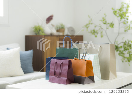 A woman returning home from shopping A woman returning home from shopping 129233255