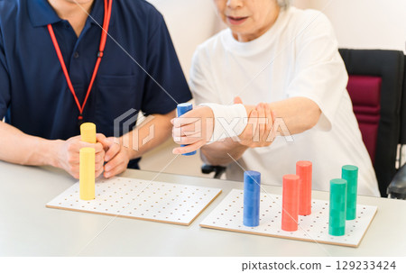 Occupational therapists working at nursing and rehabilitation facilities and senior women undergoing rehabilitation 129233424
