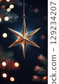 Stunning Silver Star Dazzling on Elegant Black Velvet with Radiant Golden Bokeh Effects 129234207