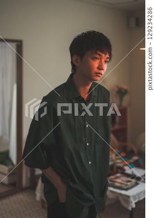 一個沉思的年輕人在他的房間裡 129234286