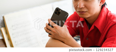 Smartphone and male performer Smartphone and male performer 129234327