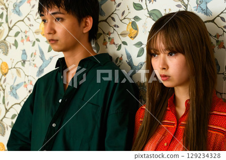 Profile fashion photo of a couple standing side by side Profile fashion photo of a couple standing side by side 129234328