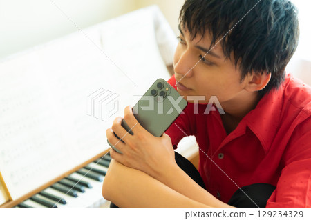 Smartphone and male performer Smartphone and male performer 129234329