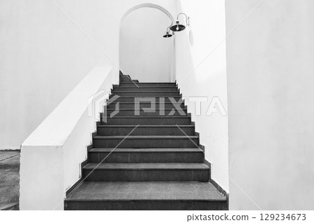 Concrete steps leading up. Stone staircase under archway in old town, historic site. Monochrome photo. Abstract steps, cement stairs, stairway at the monuments and landmarks, steps, nobody 129234673
