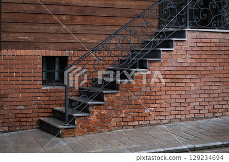 Old Brick External Stairs with railings. Brick Staircase with red brick steps. Entrance to vintage house. Travel photo, street view, nobody Old Brick External Stairs with railings. Brick Staircase with red brick steps. Entrance to vintage house. Travel photo, street view, nobody 129234694