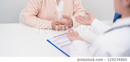 Doctor explaining diagnosis and treatment plan to elderly patient during hospital appointment. Senior patient talking doctor to disease. medical consulting, geriatric care, healthcare concept Doctor explaining diagnosis and treatment plan to elderly patient during hospital appointment. Senior patient talking doctor to disease. medical consulting, geriatric care, healthcare concept 129234860