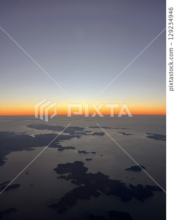 A sunset glow seen from an airplane 129234946