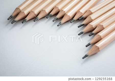 Aligned Graphite Pencils on Light Gray Background 129235168