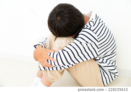 A depressed elementary school boy who stays in his room A depressed elementary school boy who stays in his room 129235615